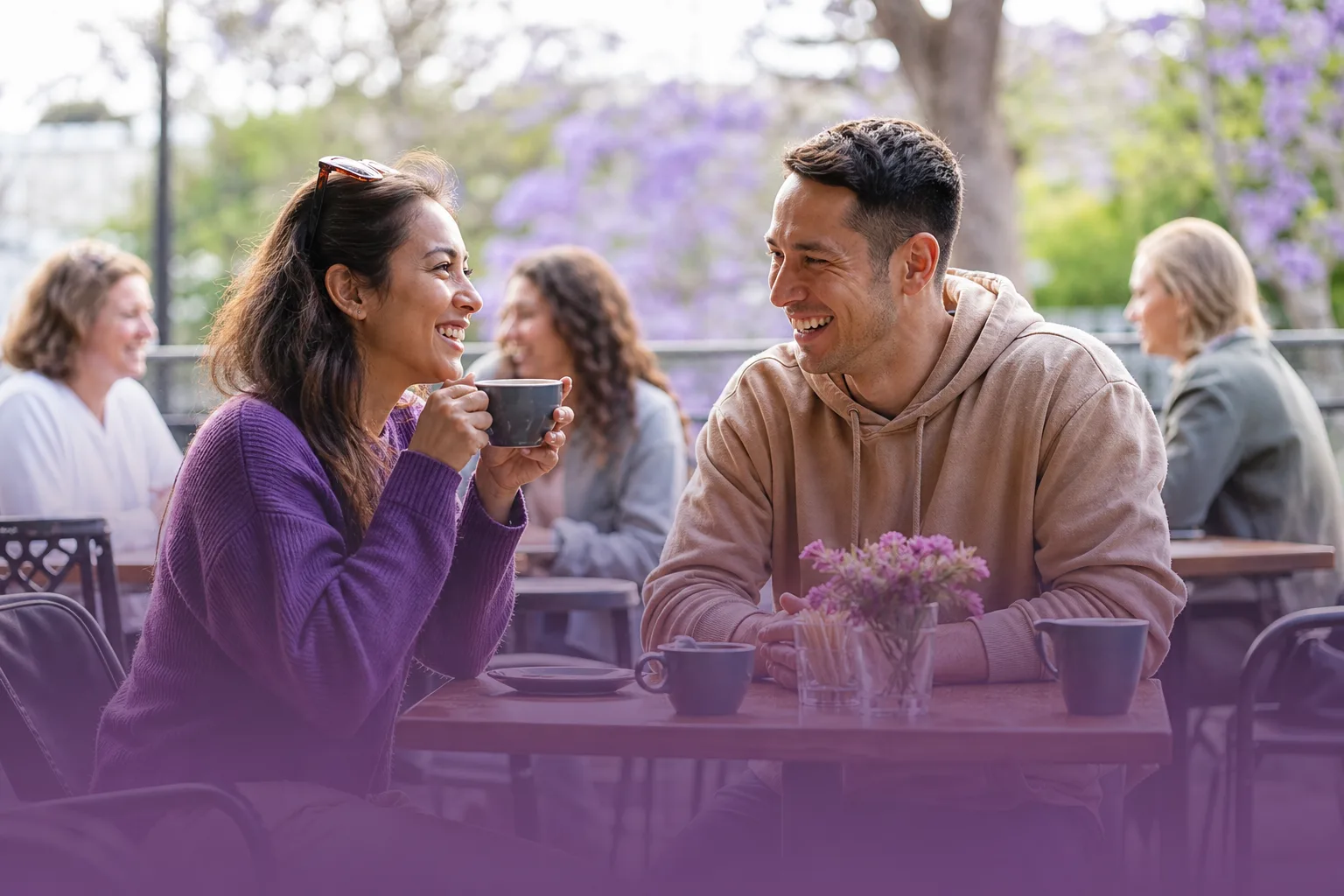 Two people chatting over coffee in Canterbury city centre